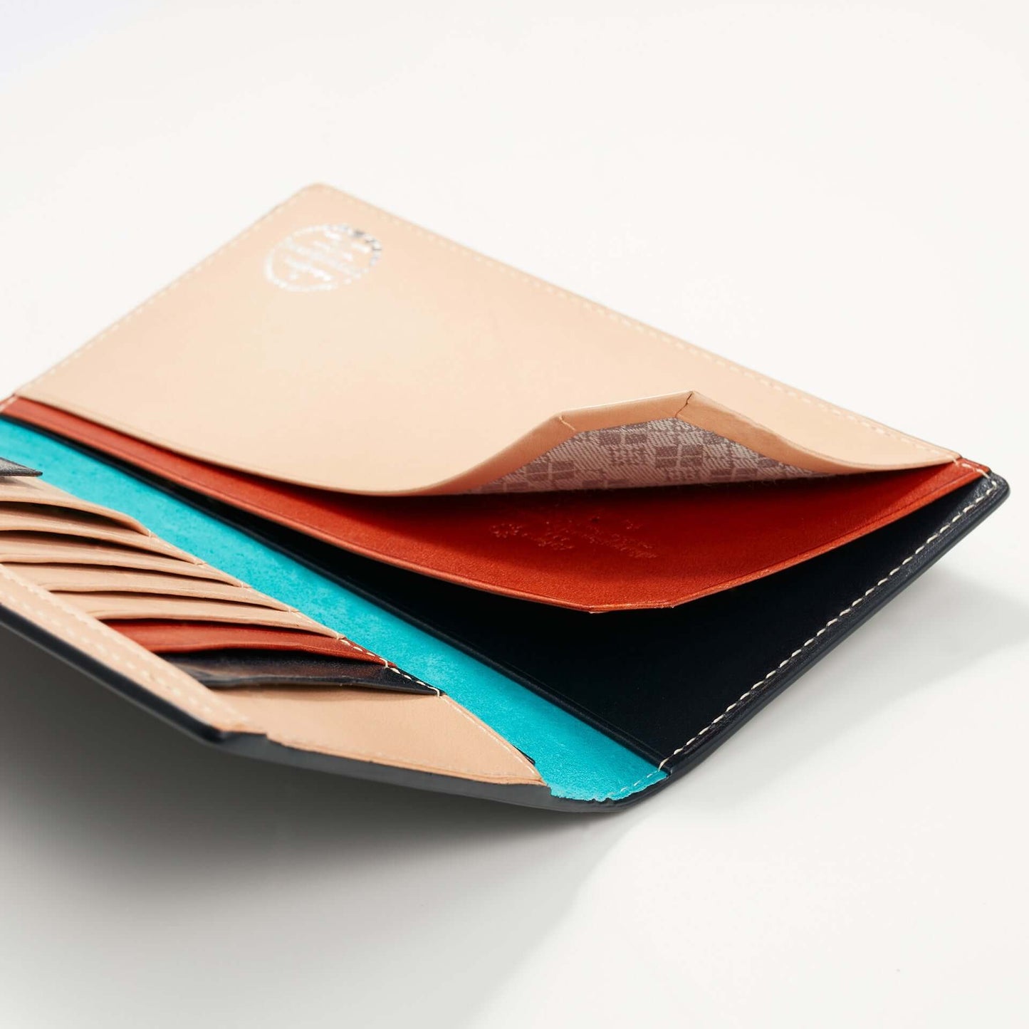Interior view of a non-stitch cordovan long wallet showcasing card slots and open pockets.